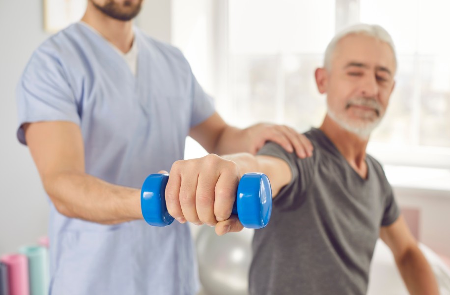 Patient working with therapist on exercise ball
